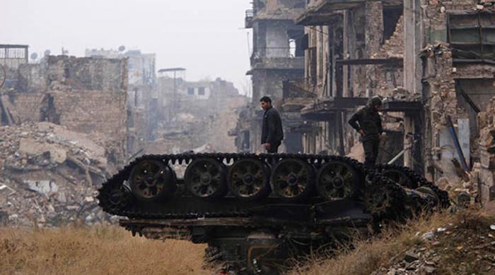 ATTENTION EDITORS - REUTERS PICTURE HIGHLIGHTForces loyal to Syria's President Bashar al-Assad stand atop a damaged tank near Umayyad mosque, in the government-controlled area of Aleppo, during a media tour, Syria December 13, 2016. REUTERS/Omar Sanadiki     TPX IMAGES OF THE DAYREUTERS NEWS PICTURES HAS NOW MADE IT EASIER TO FIND THE BEST PHOTOS FROM THE MOST IMPORTANT STORIES AND TOP STANDALONES EACH DAY. Search for 
