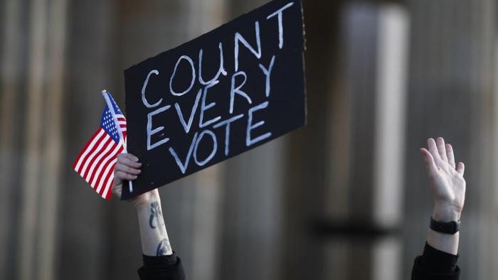 A woman shows a poster as she attends a rally of the organization Democrats abroad after the election in the United States, in Berlin, Germany, Wednesday, Nov. 4, 2020. The demonstrators demand that all votes have to count at the United States elections. (Photo/Markus Schreiber)