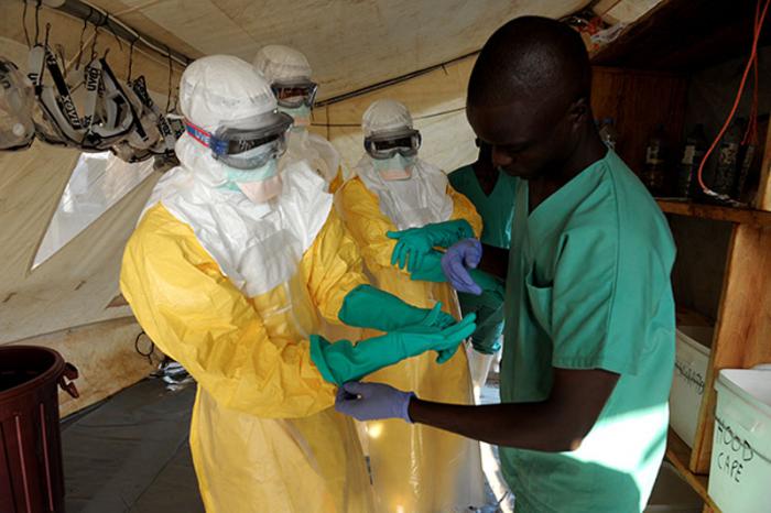 Health specialists work in an isolation ward for patients at the  Doctors Without Borders facility in GuÈkedou, southern Guinea.   Guinea's President Alpha Conde warned of a 
