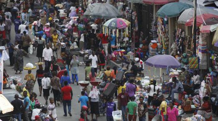 Pedestrians shop for wares in a Market in Lagos, Nigeria, Thursday, Aug. 7, 2014.  Authorities in West African are battling to contain the spread of Ebola but will have to wait for months until a potentially life-saving experimental drug known as ZMapp, which was used on two Americans infected with the dreaded disease, could be produced for use in Africa. (AP Photo/Sunday Alamba)