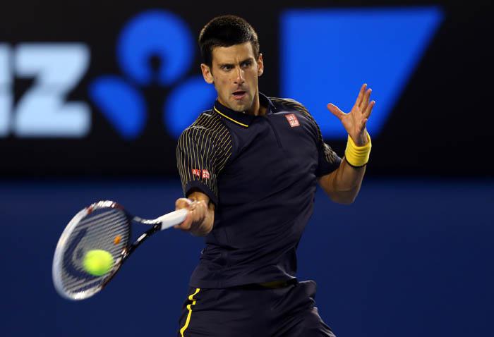 MELBOURNE, AUSTRALIA - JANUARY 16:  Novak Djokovic of Serbia plays a backhand in his second round match against Ryan Harrison of USA during day three of the 2013 Australian Open at Melbourne Park on January 16, 2013 in Melbourne, Australia.  (Photo by Julian Finney/Getty Images)