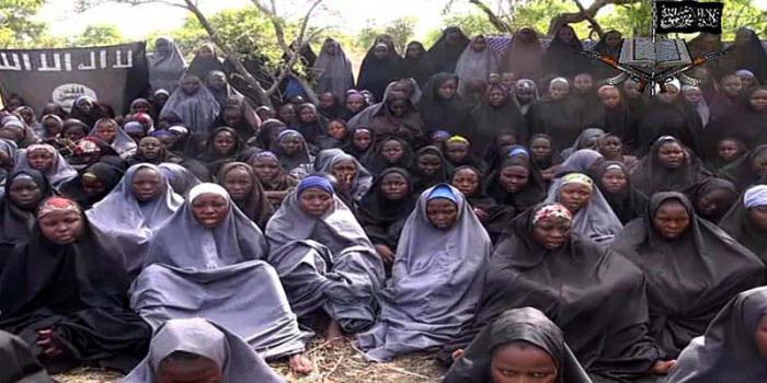 ATTENTION EDITORS - PICTURES SHOWING ABDUCTED MINORS CAN BE BLURED AT YOUR DISCRETION
A screengrab taken on May 12, 2014, from a video of Nigerian Islamist extremist group Boko Haram obtained by AFP shows girls, wearing the full-length hijab and praying in an undisclosed rural location. Boko Haram released a new video on claiming to show the missing Nigerian schoolgirls, alleging they had converted to Islam and would not be released until all militant prisoners were freed.  A total of 276 girls were abducted on April 14 from the northeastern town of Chibok, in Borno state, which has a sizeable Christian community. Some 223 are still missing. Nigeria's military and presidency  claimed on October 17, 2014 to have reached a deal with Boko Haram militants on a ceasefire and the release of more than 200 kidnapped schoolgirls. AFP PHOTO / BOKO HARAM 
RESTRICTED TO EDITORIAL USE - MANDATORY CREDIT 