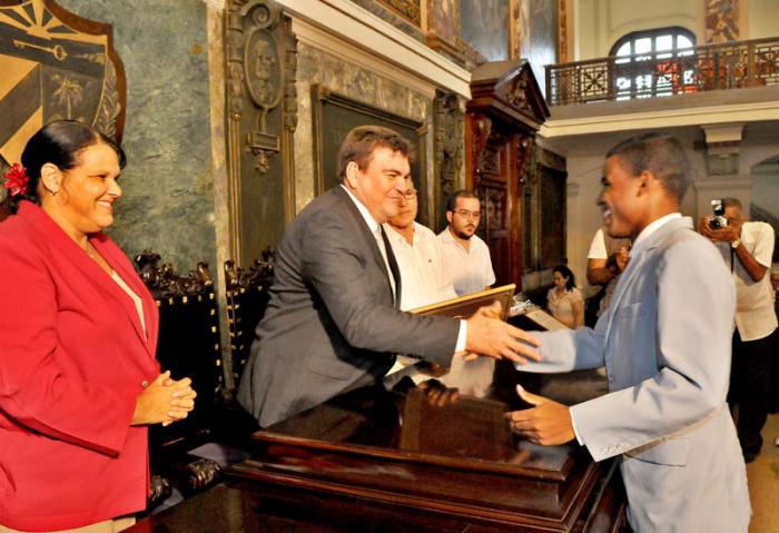 Graduaciòn de alumnos màs integrales de la Unioversidad de La Habana, Wichy Pedroso estudiante màs integral de la Facultad de Comunicaciòn, recibe el premio al mèrito cientìfico de manos del rector de La Universidad Gustavo Cobreiro en el Aula Magna