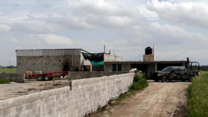 Soldiers guard the site where a tunnel, connected to the Altiplano Federal Penitentiary and used by drug lord Joaquin 'El Chapo' Guzman to escape, was located in Almoloya de Juarez, on the outskirts of Mexico City, July 12, 2015. National Security Commissioner Monte Alejandro Rubido said 18 officials from the penitentiary had been taken in for interrogation at the unit of the Attorney General's office specializing in organized crime. Mexico's most notorious drug lord Joaquin 