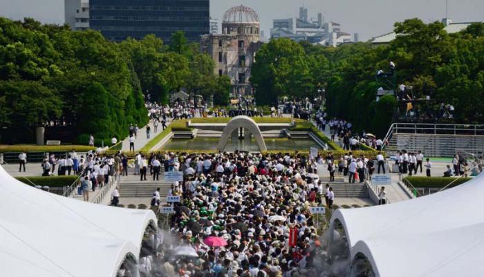 People head for the cenotaph (C) to pray for the victims of the 1945 atomic bombing of Hiroshima at the Peace Memoral Park in Hiroshima on August 6, 2013 as ceremonies are held to mark the 68th anniversary of the bombing. Tens of thousands, including ageing survivors, relatives, government officials and foreign delegates observed a moment of silence at 8:15 am local time, the time of the detonation which turned the city into a nuclear inferno in 1945.        AFP PHOTO / TORU YAMANAKA
