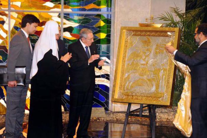 El presidente de los Consejos de Estado y de Ministros, General de Ejército Raúl Castro Ruz , obsequia a Su Santidad Kirill , Patriarca de Moscú y de toda Rusia, la obra Amanecer, del artista cubano de la plástica Alexis Leiva Machado (Kcho) 