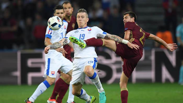 LILLE, FRANCE - JUNE 15:  Michal Duris of Slovakia holds off Georgi Schennikov of Russia during the UEFA EURO 2016 Group B match between Russia and Slovakia at Stade Pierre-Mauroy on June 15, 2016 in Lille, France.  (Photo by Matthias Hangst/Getty Images)