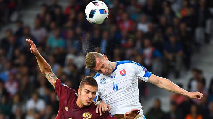 Russia's midfielder Roman Neustaedter (L) vies with Slovakia's defender Jan Durica during the Euro 2016 group B football match between Russia and Slovakia at the Pierre-Mauroy stadium Villeneuve-d'Ascq, near Lille on June 15, 2016. / AFP / Joe KLAMAR        (Photo credit should read JOE KLAMAR/AFP/Getty Images)