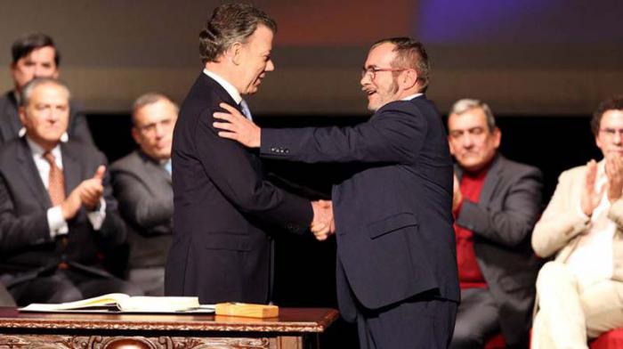 El presidente Santos (izquierda) y el Comandante de las FARC-EP, Timoleón Jiménez, volvieron a estrechar sus manos al oficializar el nuevo tratado.
