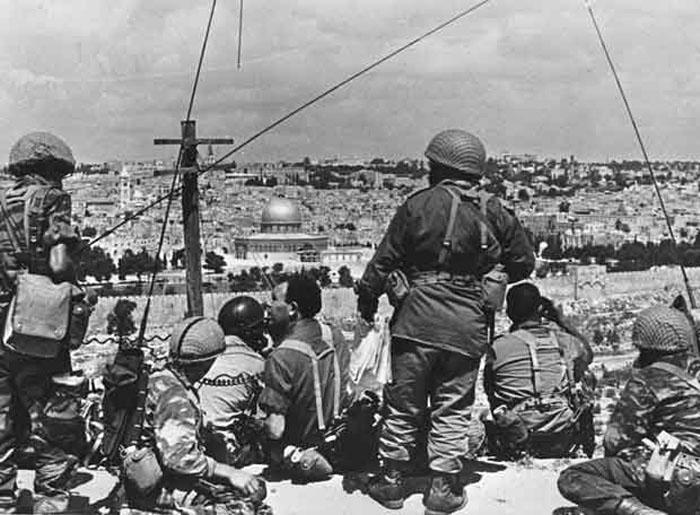 In this photo released by the Government Press Office, Israeli Commander Motta Gur and his troops survey Jerusalem's Old City before launching their attack during the Six Day War June, 1967. Four decades after an underdog Israeli military campaign that captured the world's imagination, the people of Israel, the Middle East and the world are are still struggling to come to terms with it. The war tripled Israel's size and probably prevented its annihilation. But with victory came burdens, hatreds and many, many deaths for Israelis and the Palestinians in their newly-expanded territory. (AP Photo/Government Press Office) ** ISRAEL OUT **