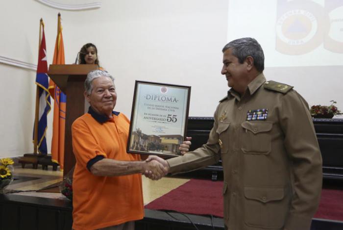 Acto por el 55 Aniversario de la Defensa Civil, en el Estado Mayor Nacional de la Defensa Civil. En la foto el General de Brigada Jorge Luis Méndez de la Fe, J´de Dirección del MINFAR, entrega un diploma al General de División y Presidente del a Asociación Nacional de Combatientes de la Revolución Cubana, José A. Carrillo Gómez.