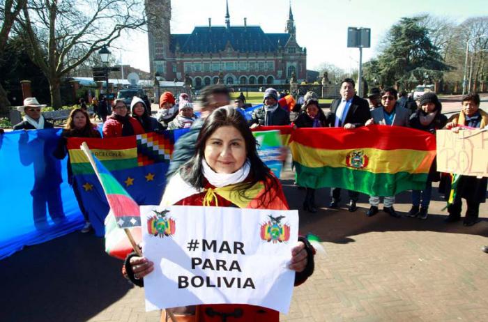 Una mujer sostiene el cartel Mar para Bolivia durante una manifestación de ciudadanos bolivianos fuera de la Corte Internacional de Justicia en La Haya. 