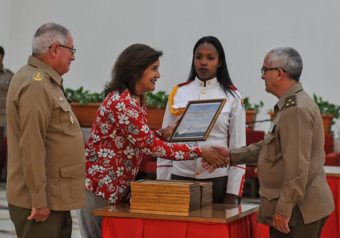 Acto Político por el día de la Ciencia Cubana en las Fuerzas Armadas Revolucionarias, en el MINFAR, hacen entrega de los certificados acreditativos el General de Cuerpo de Ejército Álvaro López Miera (I), viceministro primero de las Fuerzas Armadas Revolucionarias Jefe del Estado Mayor General y la  Master en Filosofía, Elba Rosa Pérez Montoya (C.I), ministra de Ciencia, Tecnología y Medio Ambiente a el Coronel Francisco Bode Valdés (D) por modernización del canal teleóptico del Complejo coheteril  antiaéreo ¨OSA-AK¨.