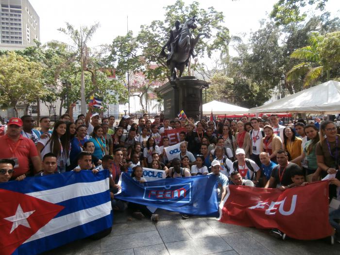 Delegados cubanos al 18vo. clae junto a la estatua de Bolívar.