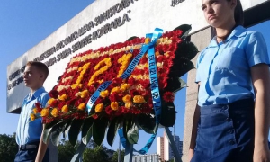 La ofrenda floral colocada en nombre del pueblo cubano es escoltada por estudian