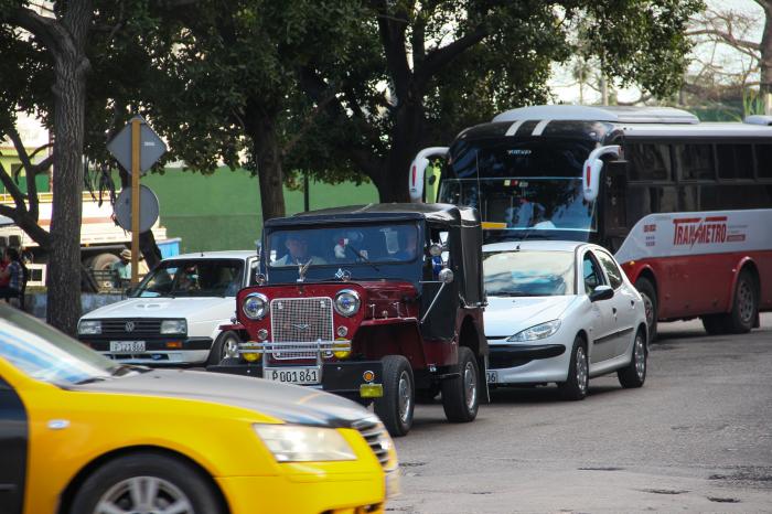 La Habana, su transporte y gente en Cuatro Caminos en Habana Vieja.