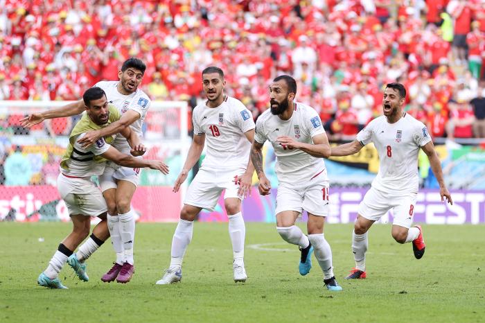 DOHA, QATAR - NOVEMBER 25: Roozbeh Cheshmi of IR Iran celebrates with teammates after scoring their team's first goal during the FIFA World Cup Qatar 2022 